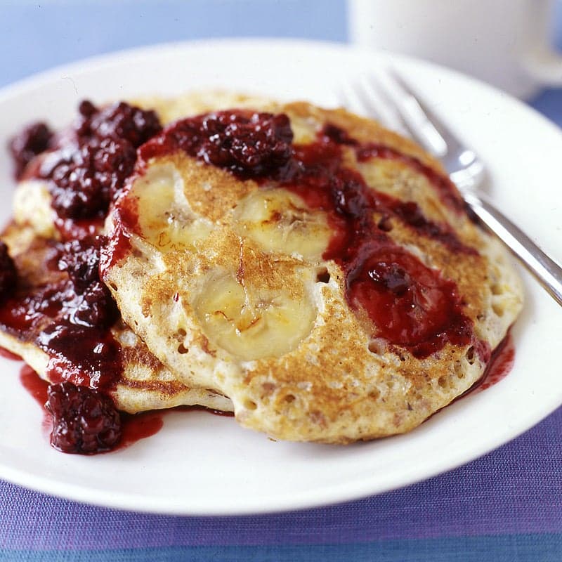 Whole-grain banana pancakes with blackberry syrup